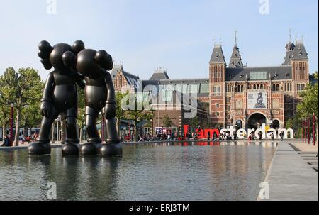 Sculture di New York artista KAWS durante il ArtZuid mostra sulla piazza Museumplein, Amsterdam. Il Rijksmuseum in background Foto Stock