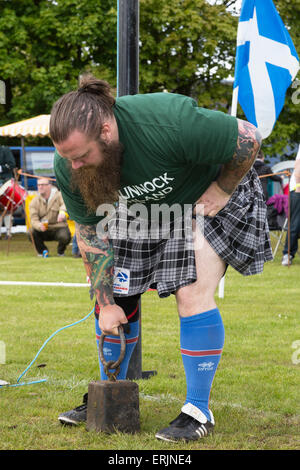 Concorrente alla Carmunnock Highland Games si prepara a lanciare il 28 libbra di peso sopra la barra alta, Carmunnock vicino a Glasgow, S Foto Stock