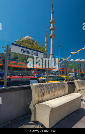 Aprire forma di libro banco a Eminonu stazione del tram con Yeni Cami o moschea nuova dietro, Istanbul, Turchia Foto Stock