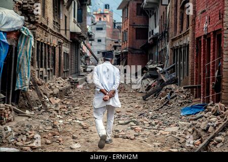 Un uomo nepalese passeggiate attraverso le rovine di un vicolo di Giugno 4, 2015 in Sabnkhu, Nepal. Il devastante terremoto che ha colpito il piccolo regno del Nepal ha ucciso oltre 8 mila persone e distrutto gran parte del paese. Foto Stock