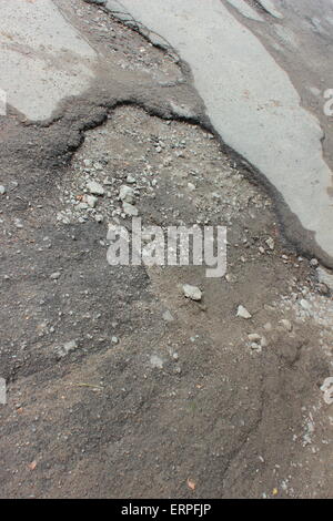 La guida pericolosa road con fori in asfalto Foto Stock