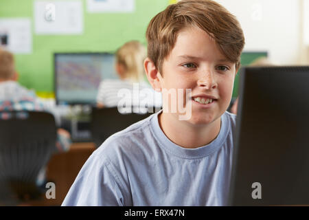Maschio di scuola elementare allievo nella Classe Computer Foto Stock