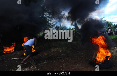 Manado, Indonesia. 09 Giugno, 2015. Servizio civile unità di polizia ( Satpol PP ) scontro con i residenti come demolizione di edifici illegali nel villaggio Pangiang avviato. Gli scontri innescati quando i due acri di terra che appartiene alla Multi cibo afferrato dai residenti in quanto essi sostengono che i governi' proprietà. © Inayah Azmi Atifah/Pacific Press/Alamy Live News Foto Stock