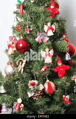 Albero di Natale decorato con sfere e bambole in miniatura nella festa di Natale Foto Stock