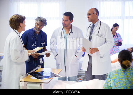 I medici facendo turni e consulenza nella stanza di ospedale Foto Stock