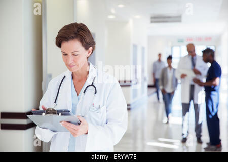 Medico utilizzando digitale compressa nel corridoio di ospedale Foto Stock