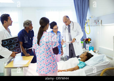I medici e gli infermieri facendo turni nella stanza di ospedale Foto Stock