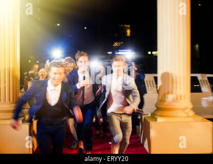 Celebrità entusiasta che arrivano e acceso da paparazzi fotografi al red carpet event Foto Stock