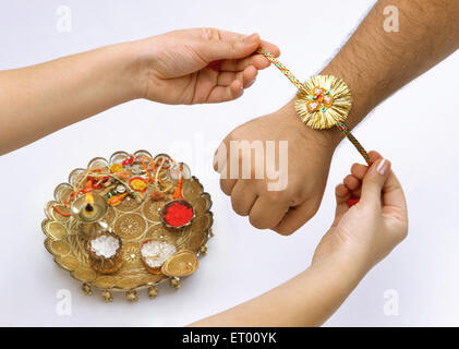 Raksha Bandhan festival ; sorella rakhi legatura sul fratello la mano ; Bombay ora Mumbai ; Maharashtra ; India Foto Stock