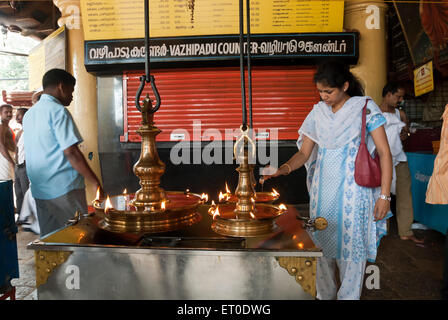 Donna versando olio in diya in kali bhagavathy tempio ; Kodungallur ; Kerala ; India Signor#777L Foto Stock