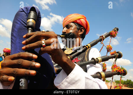 Uomo indiano che gioca bagpipe, Rajasthan, India Foto Stock