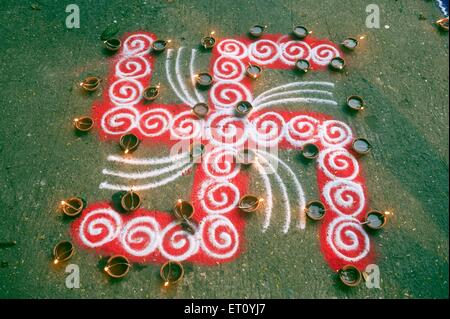 Simbolo svastica con lampade ad olio, festival Diwali, India, Asia Foto Stock