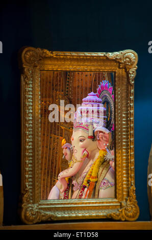 Dimensione verticale la riflessione di un idolo del Ganesha in uno specchio in un pandal Mumbai India Asia Foto Stock