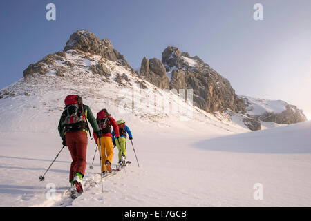 Chi pratica lo sci alpinismo arrampicata sul picco innevato, Tirolo, Austria Foto Stock