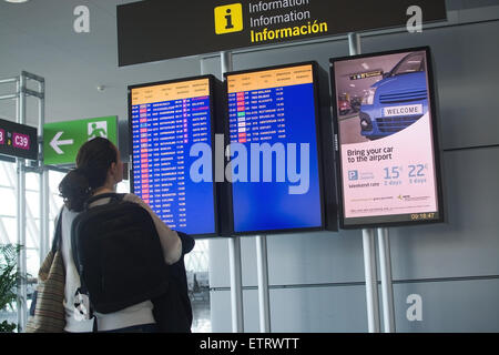 Donna di lettura di informazioni di partenza sign in Palma di Son Sant Joan aeroporto internazionale in aprile 24, 2015 in Palma de Mallorca. Foto Stock
