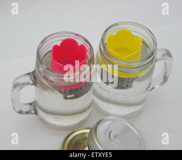 Il tea maker in un vaso di acqua su un fondo bianco . Foto Stock