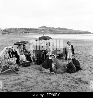 Le famiglie si ripara dalla pioggia sotto le coperte e ombrelloni sulla spiaggia di Barry Island, Vale of Glamorgan, Galles. Il 14 luglio 1960. Foto Stock