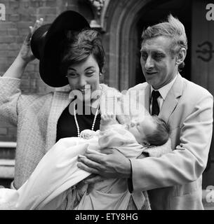 Spike Milligan con moglie Paddy tenendo il loro nuovo arrivo, Jane Fionulla Marion, al suo battesimo a Finchley Albans Chiesa, Londra. Il 26 giugno 1966. Foto Stock