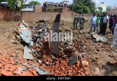 Di Allahabad, India. 16 Giugno, 2015. Le persone si radunano vicino al si è schiantato Jaguar degli aerei da caccia della forza aerea indiana di questa mattina a Chaka in Naini nei pressi di Allahabad in Uttar Pradesh. Entrambi i piloti sono riusciti a espellere in modo sicuro. Il piano che aveva preso il largo a 7:25 am dall'aria Bamrauli strip di Allahabad era su una formazione di routine sortie. I piloti secondo come riferito ha inviato segnali per il personale di terra che vi è stata una delle principali tecniche di glitch con il velivolo. © Prabhat Kumar Verma/Pacific Press/Alamy Live News Foto Stock