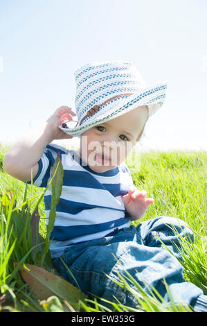 Bambino in striped t-shirt in un campo di sole Foto Stock