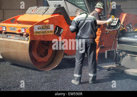 San Pietroburgo, Russia - 30 Maggio 2015: uomini al lavoro, strada urbana è in costruzione, asfaltatura in corso, il controllo di qualità Foto Stock