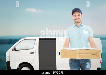 Immagine composita del corriere bello uomo con pacco Foto Stock