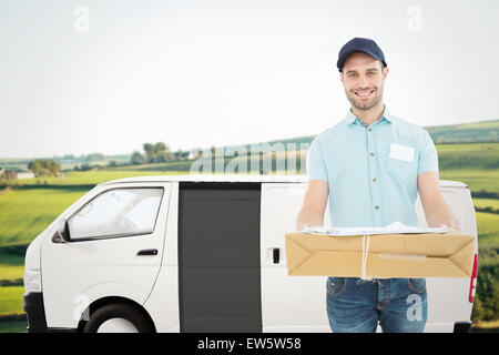 Immagine composita del corriere bello uomo con pacco Foto Stock