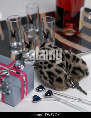 Close-up di una finta leopardskin anello chiave con il cuore a forma di bastoncini da cocktail e un regalo regalo di compleanno Foto Stock