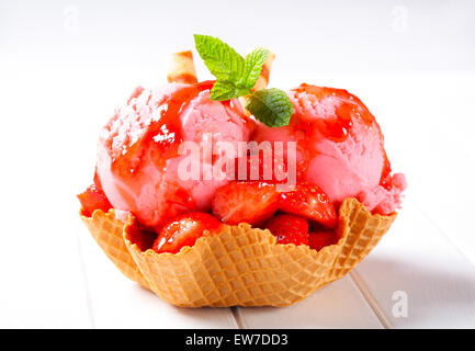 Gelato alla crema con fragole fresche nella ciotola del wafer Foto Stock