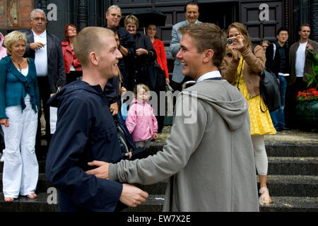 Un maschio gay giovane stand al di fuori del municipio dopo la loro cerimonia di nozze di Copenhagen, Danimarca. Foto Stock