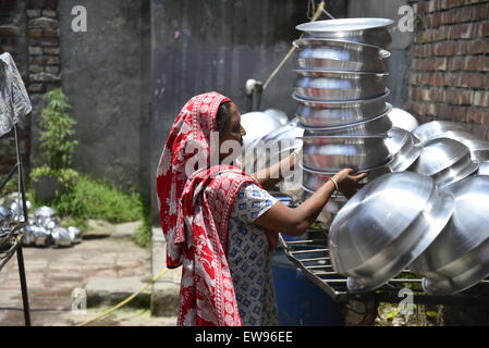 Manuale del Bangladesh fatiche delle donne lavora in una pentola in alluminio-making fabbrica, ogni lavoro guadagnare solo 300 Taka (US$ 3,87) al giorno a Dhaka, nel Bangladesh. Il 20 giugno 2015 Foto Stock