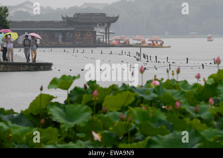 Hangzhou (Cina). Il 21 giugno, 2015. Turisti visitano il Baidi Causeway a pioggia a West Lake in Hangzhou, a est della capitale cinese della Provincia di Zhejiang, 21 giugno 2015. Molte persone sono venute a Lago Ovest il secondo giorno dei tre giorni di Dragon Boat Festival holiday, noto anche come Duanwu, domenica. Duanwu viene celebrata ogni anno il quinto giorno del quinto mese del calendario lunare cinese, che cade il 20 giugno di quest'anno. Credito: Xinhua/Alamy Live News Foto Stock