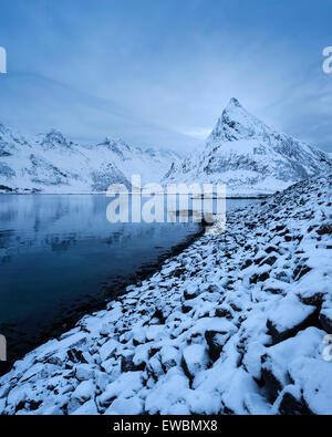 Volandstind picco di montagna sorge dal mare vicino a Fredvang ponti, Flakstadøy, Isole Lofoten in Norvegia Foto Stock
