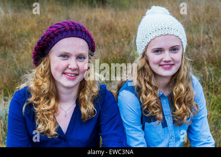 Europeo di due ragazze adolescenti indossare cappelli in natura Foto Stock