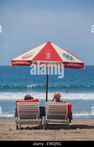 I turisti godendo di giornata di sole in spiaggia di Kuta Beach, Bali. Foto Stock