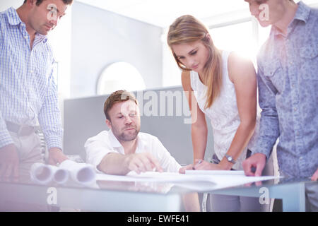 Architetti rivedendo blueprint in office Foto Stock