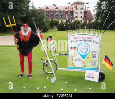 Bad Saarow, Germania. Il 30 giugno, 2015. Noleggio designer Dieter 'Didi' Senft Indossa il costume di un " tour devil' accanto alla sua " Golf " bicicletta sul campo da golf 'Faldo corso" a Bad Saarow, Germania, 30 giugno 2015. Didi ha presentato la sua ultima creazione di bicicletta per aiutare a promuovere l'offerta tedesca per il torneo di golf Ryder Cup 2022. Foto: PATRICK PLEUL/dpa/Alamy Live News Foto Stock