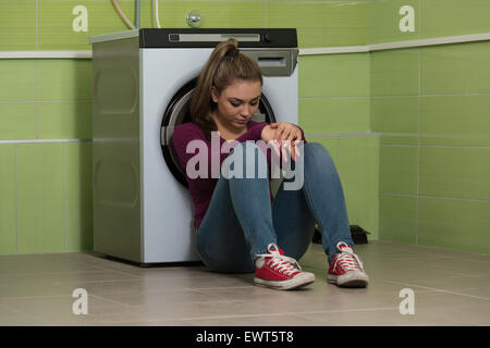 Bella ragazza sorridente nella stanza lavanderia Foto Stock