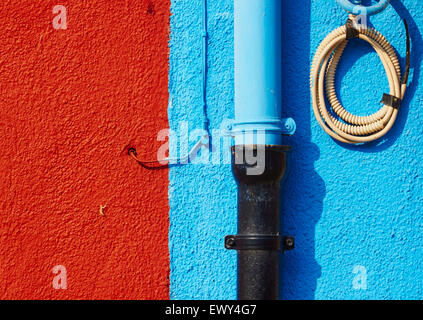 Tubi e fili su blu e ruggine parete colorata Burano Laguna di Venezia Veneto Italia Europa Foto Stock