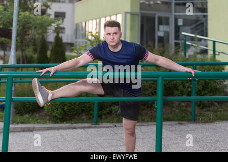 Istruttore di Fitness Portrat all'aperto facendo esercizi streching Foto Stock