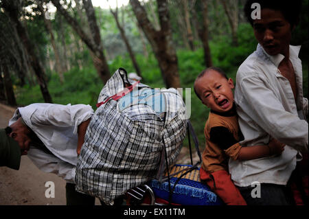 I rifugiati provenienti dal Myanmar è stato di Wa ride su un trattore al confine China-Myanmar cancello al confine della città di Mangka, Cina Yunnan Foto Stock