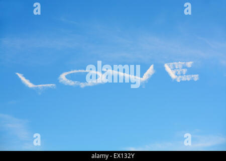 La parola amore scritto nel luminoso cielo blu Foto Stock