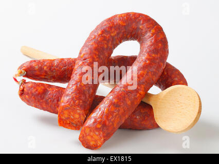 Piccante salsiccia secca e cucchiaio di legno Foto Stock