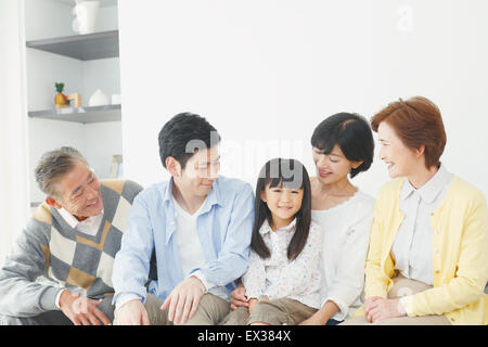 Tre generazioni di una famiglia giapponese sul divano del soggiorno Foto Stock