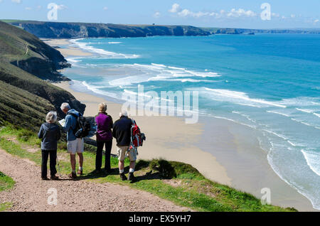 Un gruppo di escursionisti una sosta per ammirare la vista lungo il litorale della Cornovaglia vicino a Sant Agnese in Cornovaglia, England, Regno Unito Foto Stock