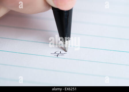 Macro di un colpo di mano la scrittura giapponese Kanji per 'felice' o 'felicità" su bianco rivestito di carta. Foto Stock