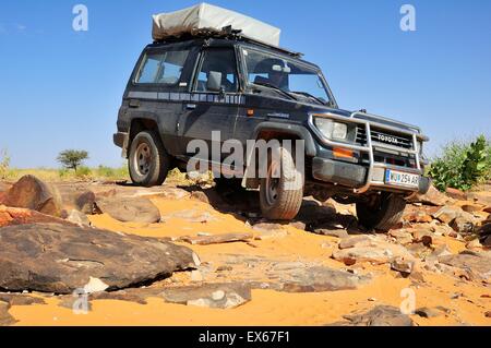 Un SUV con tetto tenda sulle Rocky via, percorso da Atar a Tidjikja, regione di Adrar, Mauritania Foto Stock