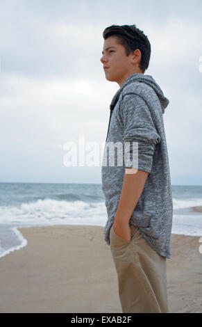 Ragazzo permanente sulla spiaggia lungo l'Oceano Atlantico Montauk Long Island New York Foto Stock