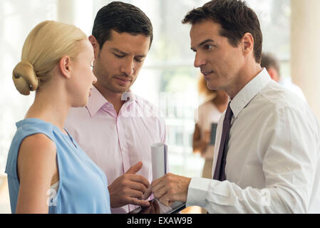 Imprenditore posizione spiegando ai colleghi Foto Stock