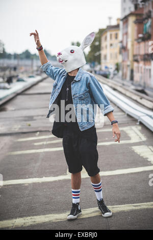 Maschera di coniglio giovane bello barbuto hipster uomo in città Foto Stock